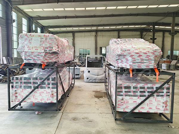 Golf carts wrapped and prepared for shipping, ensuring safe delivery to customers