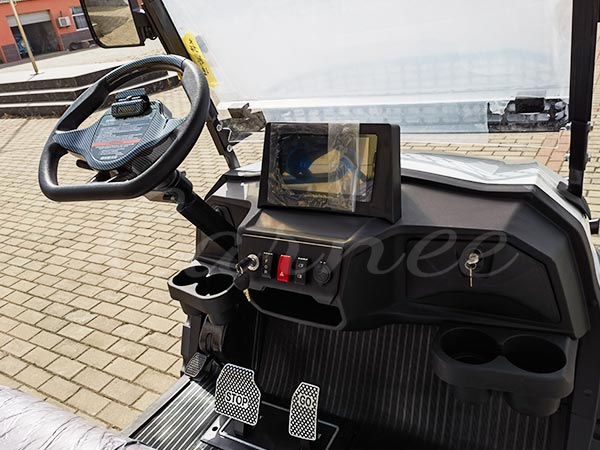 Close-up view of an electric golf cart dashboard with modern controls and digital display.