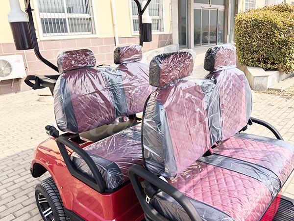 Four-seat electric golf cart interior with new, protective covers on the seats.
