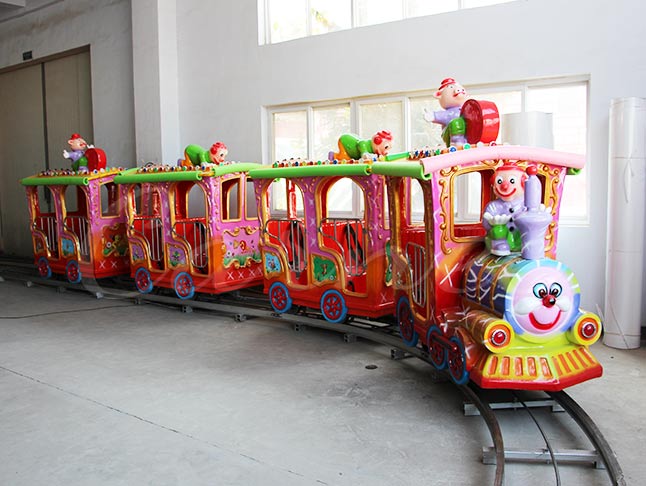 Children's amusement ride, a fun clown train with bright colors and cute design.