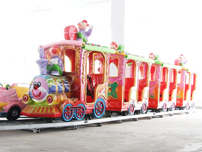 Colorful clown-themed track train for kids, featuring vibrant colors and playful design.