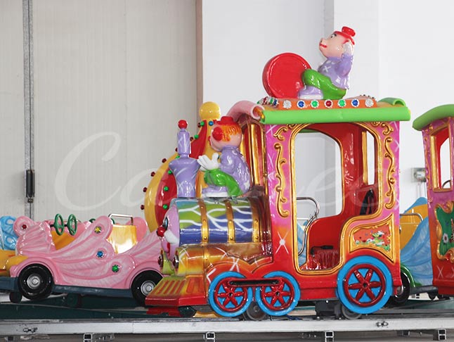 Fun and vibrant clown-themed track train ride for children, offering an entertaining experience.