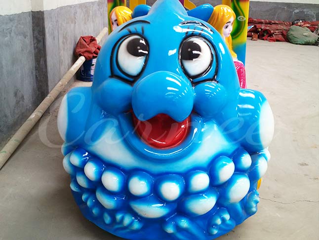 Kids ocean train ride at amusement park with colorful fish designs and undersea adventure theme