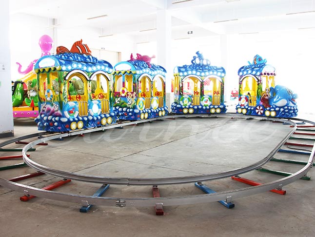 Undersea amusement park train ride featuring colorful ocean-themed carriages for children