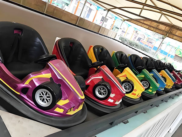 Classic bumper cars arranged in an amusement park ride area, perfect for kids and family fun