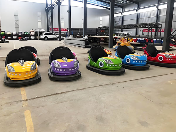 Colorful bumper cars lined up in a factory, ready for amusement park business setup