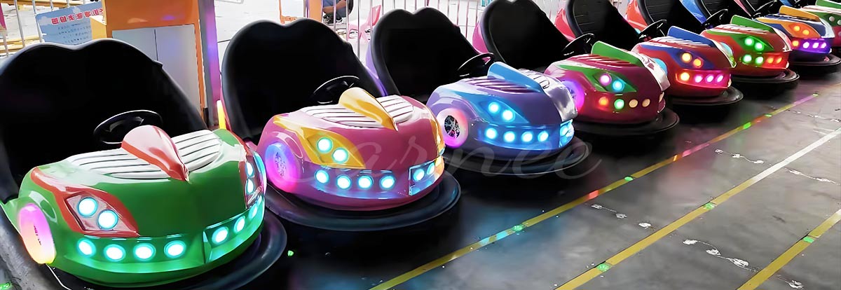 Row of colorful LED bumper cars lined up in an amusement park for visitors.