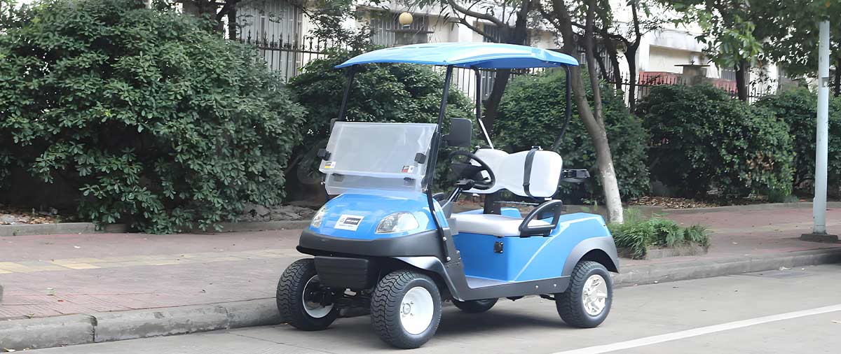 Compact blue golf cart parked by the sidewalk, illustrating average golf cart width for easy parking.