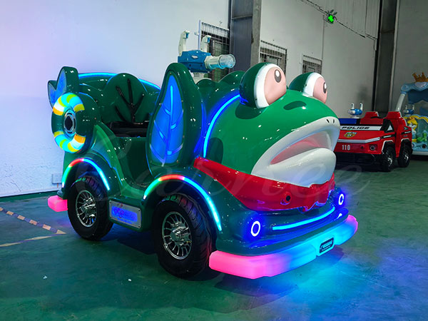 Frog-themed electric bumper car with colorful LED lights in an indoor amusement park