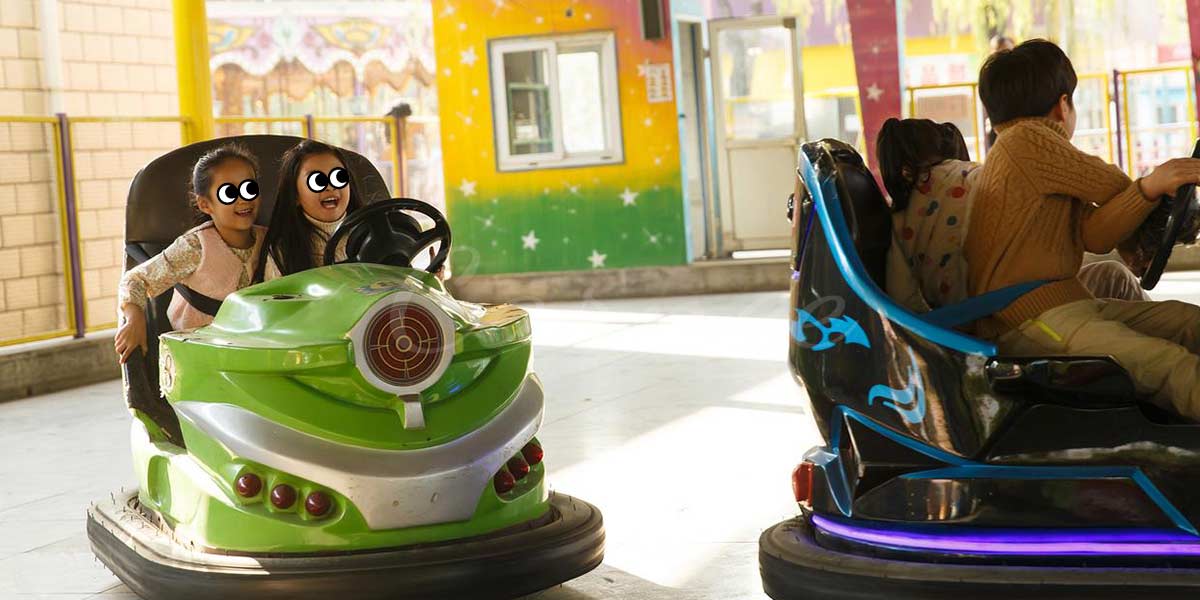 Kids driving bumper cars with safety rules in mind.