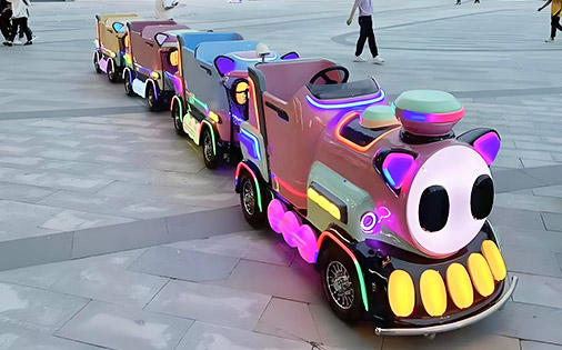 Colorful kids’ electric amusement park train ride with LED lights for safe night operation.